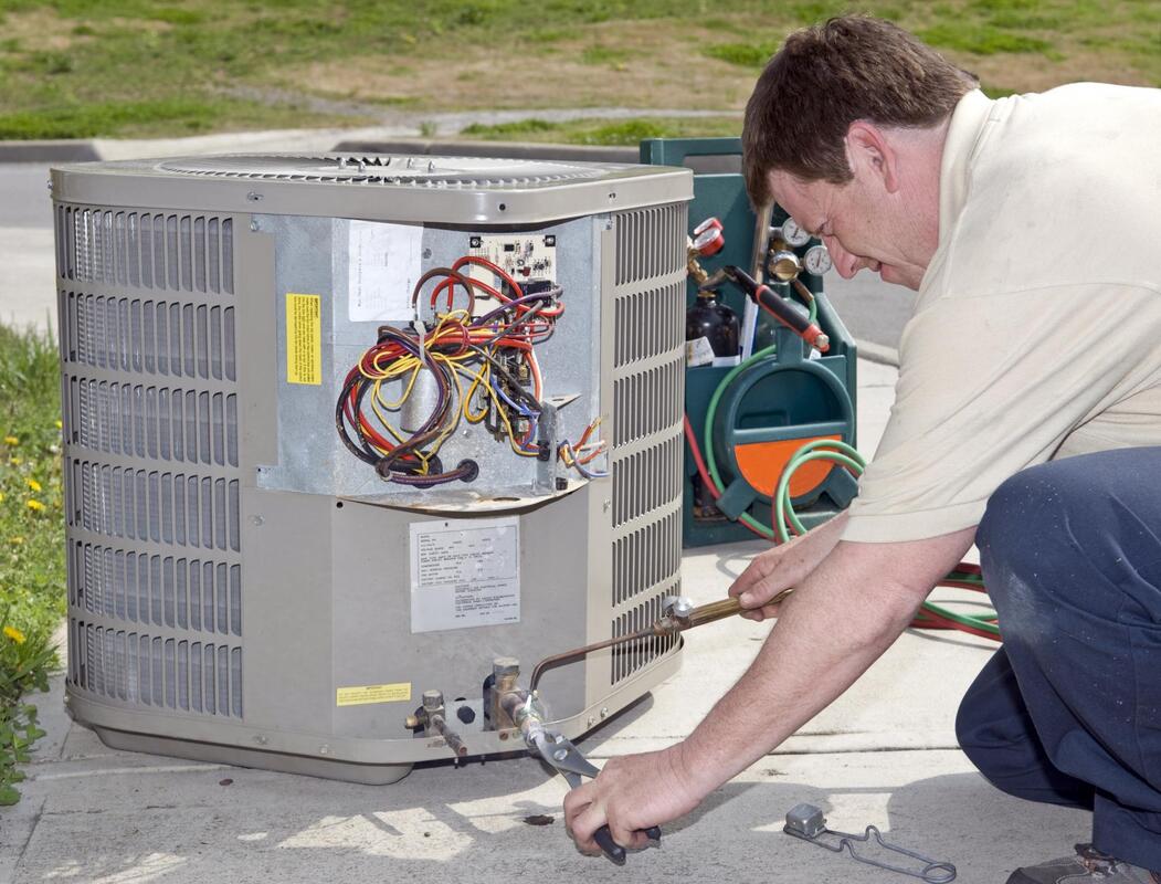 HVAC repairman doing air conditioning installation 