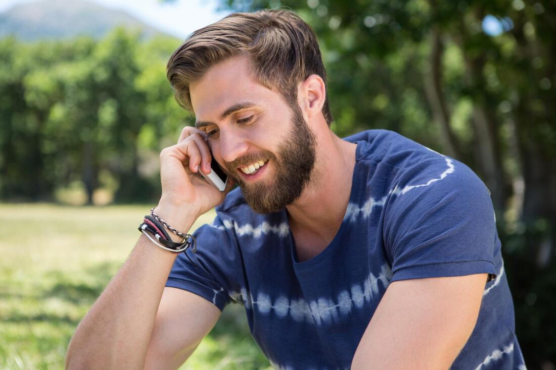 man smile taking phone call